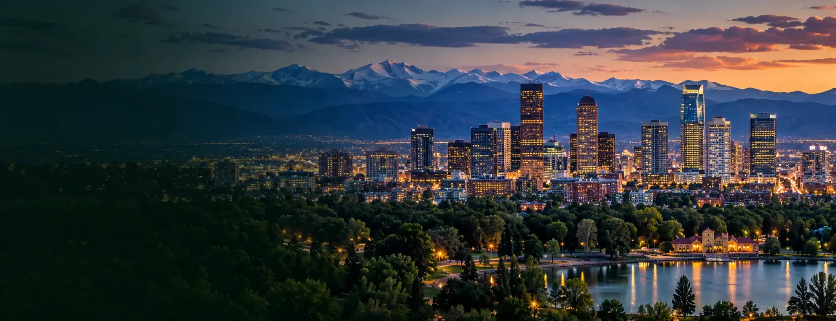 Denver skyline at night below the mountains
