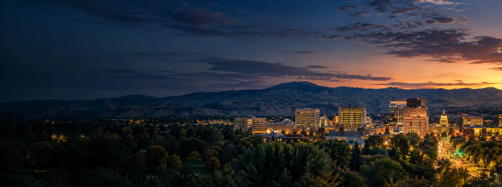 Boise lights below the foothills at dusk