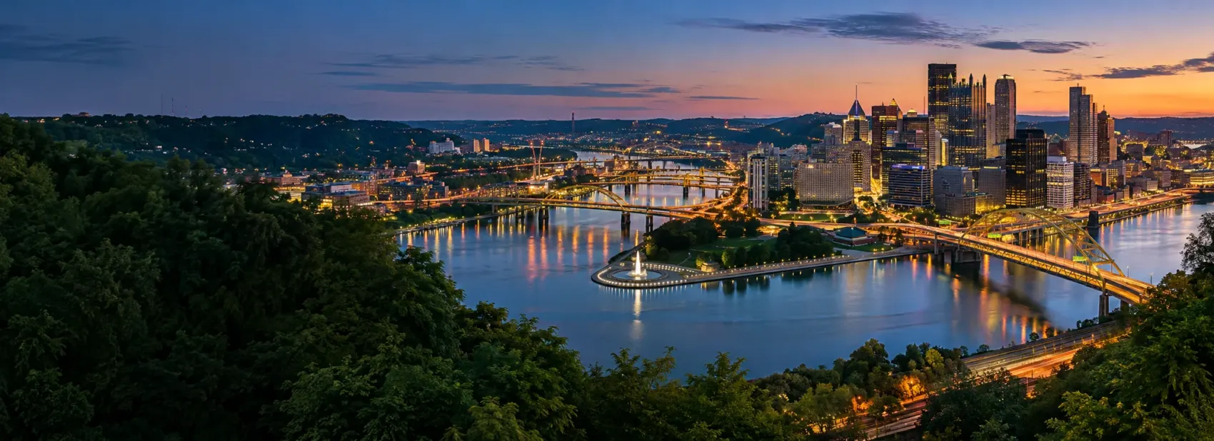Pittsburgh skyline at night over the rivers
