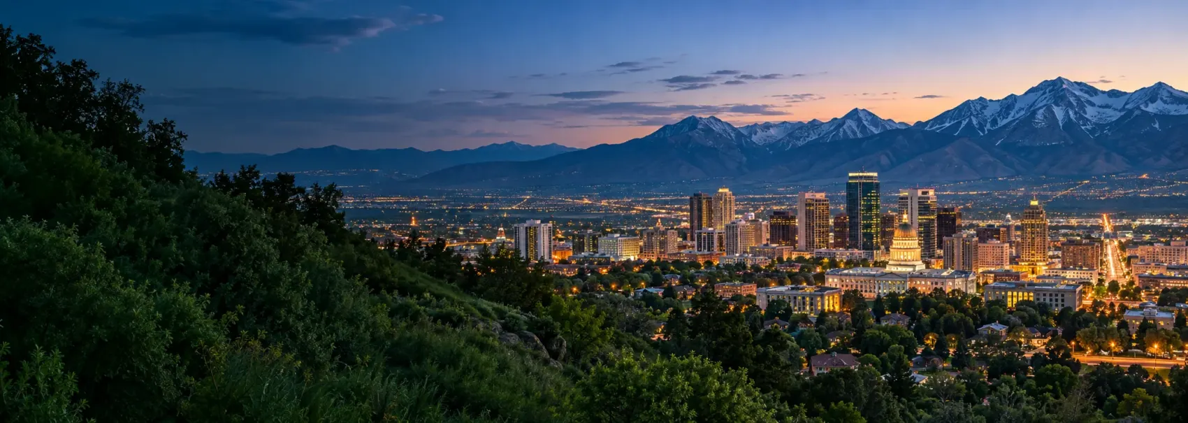 Salt Lake City lights at night below the mountains