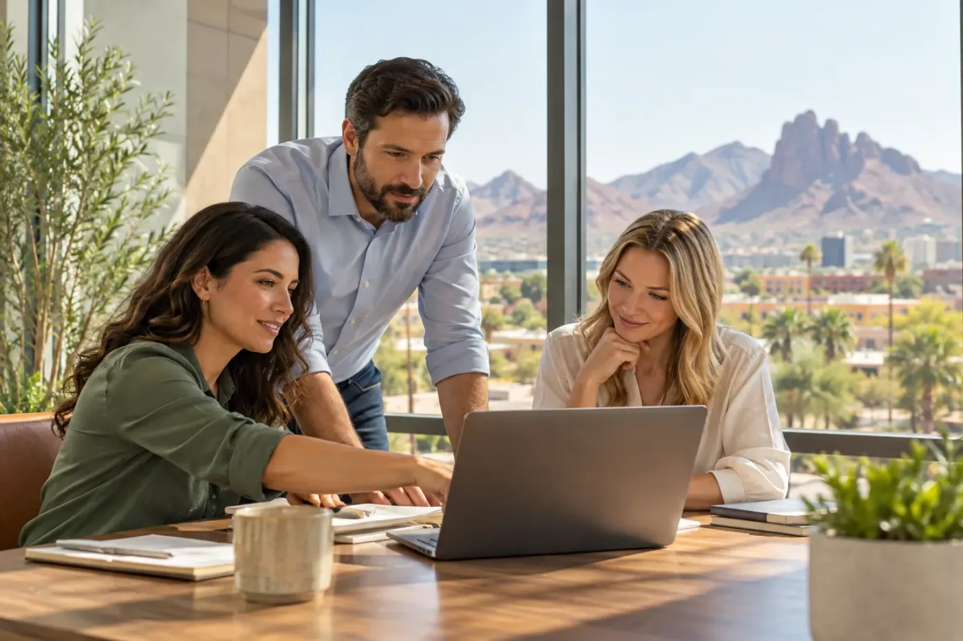 Team working at a laptop in an Arizona office