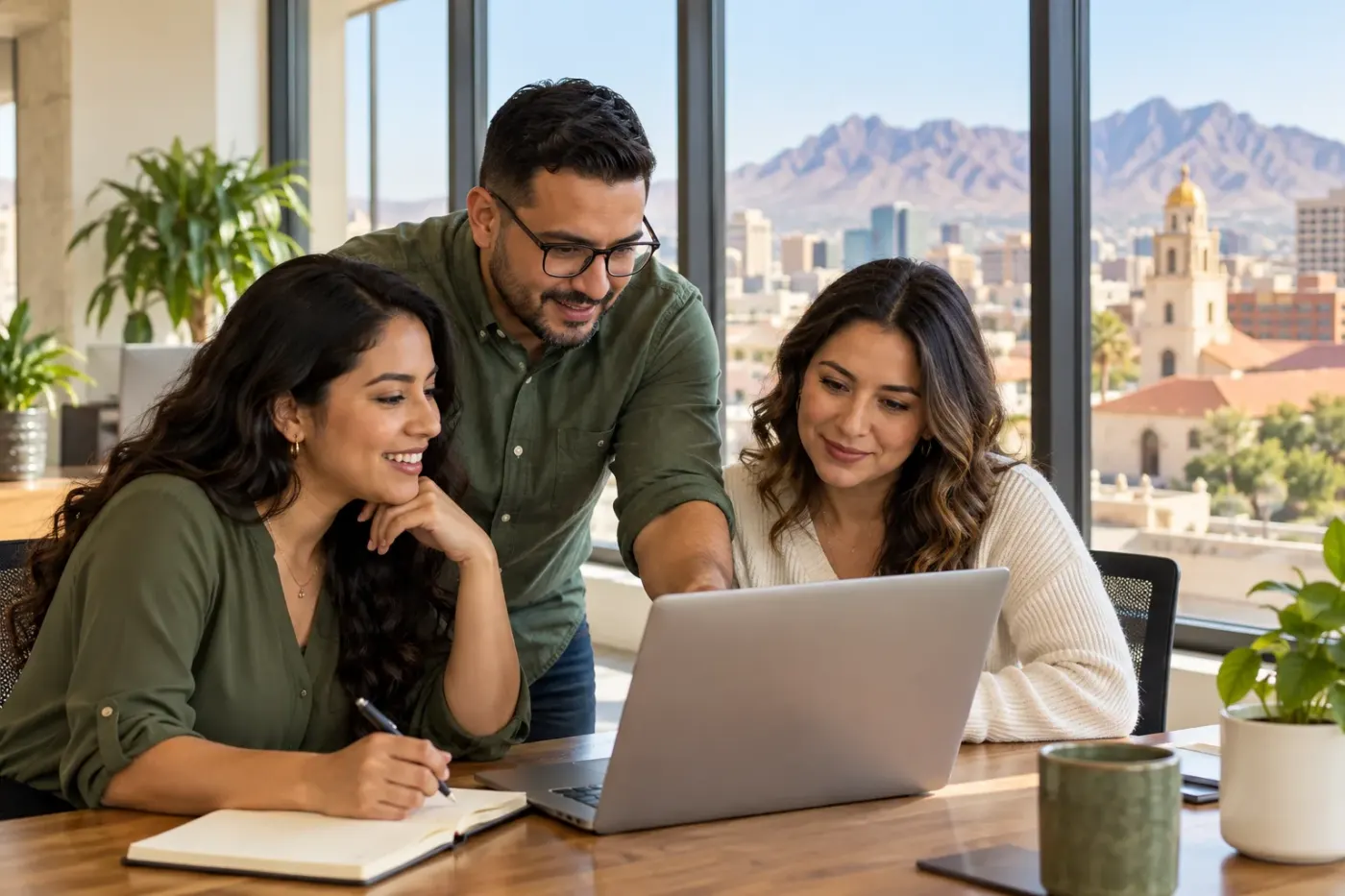 Team working at a laptop in an El Paso office
