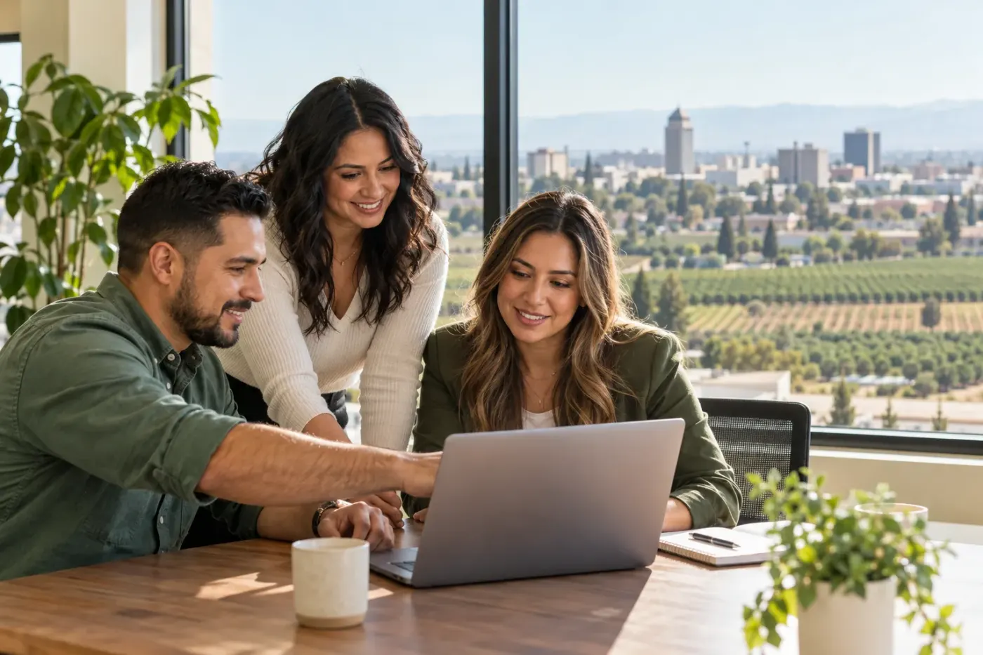 Team working at a laptop in a Fresno office