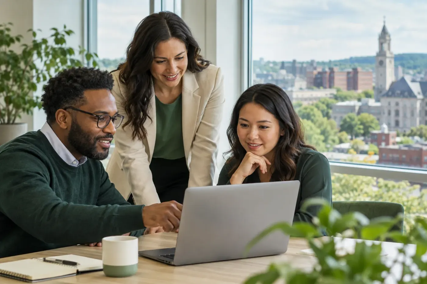 Team working at a laptop in a Massachusetts office