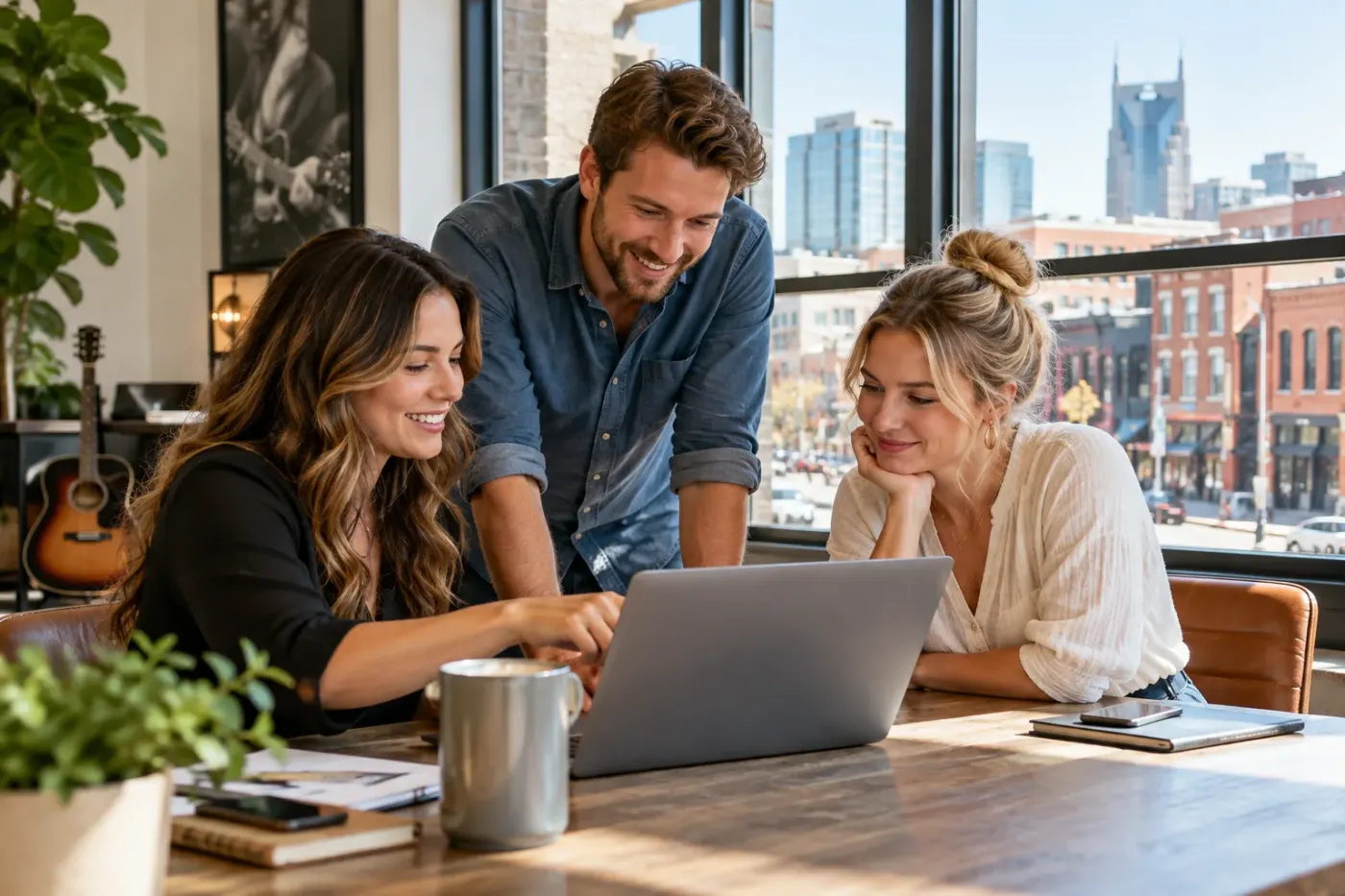 Team working at a laptop in a Nashville office