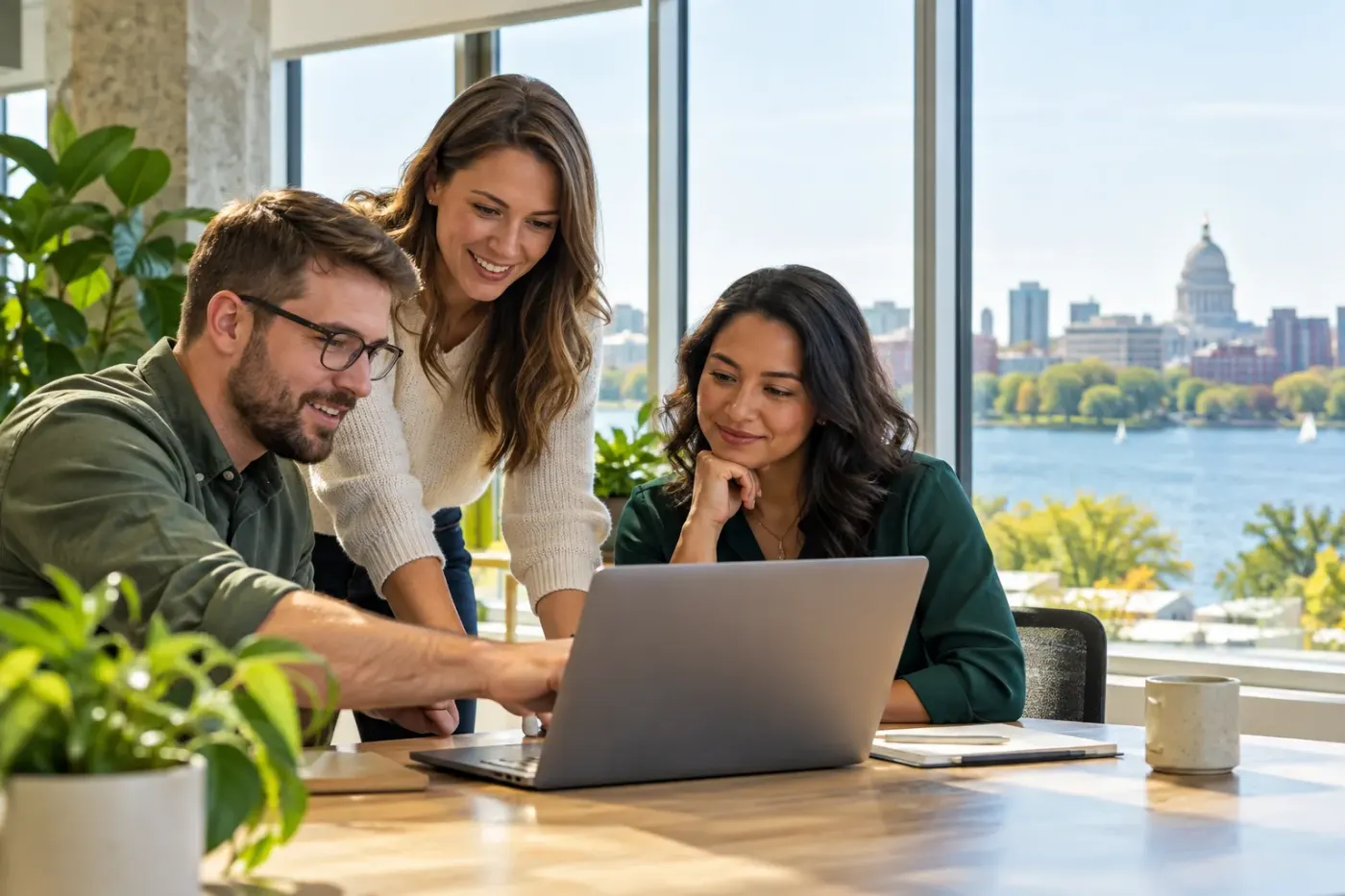 Team working at a laptop in a Wisconsin office
